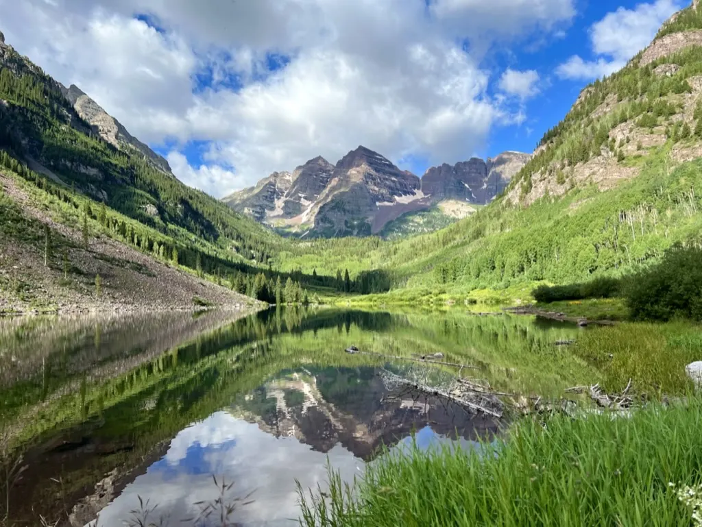 Maroon Bells reflected in a still alpine lake